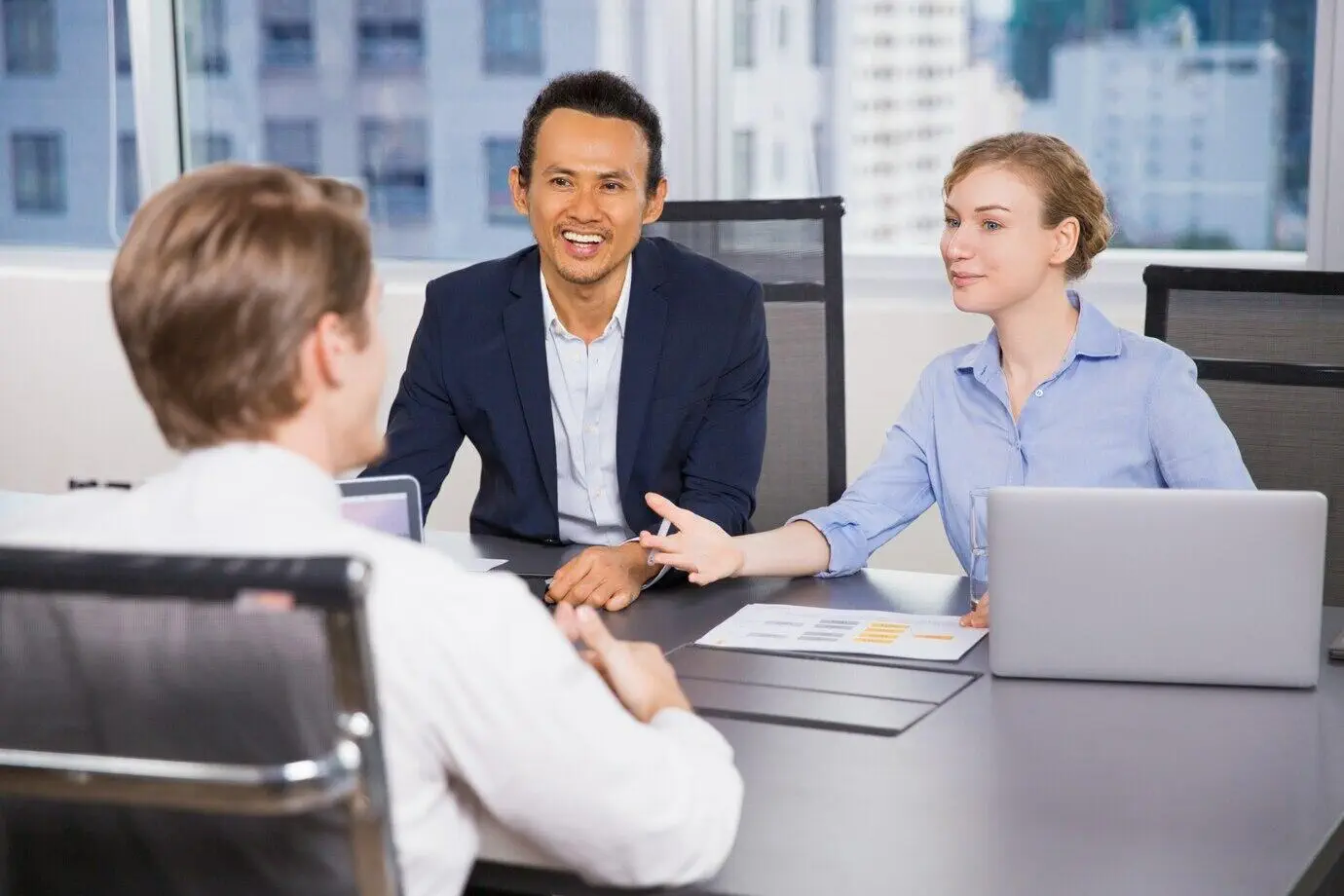 Business professionals in a meeting discussing financial matters.