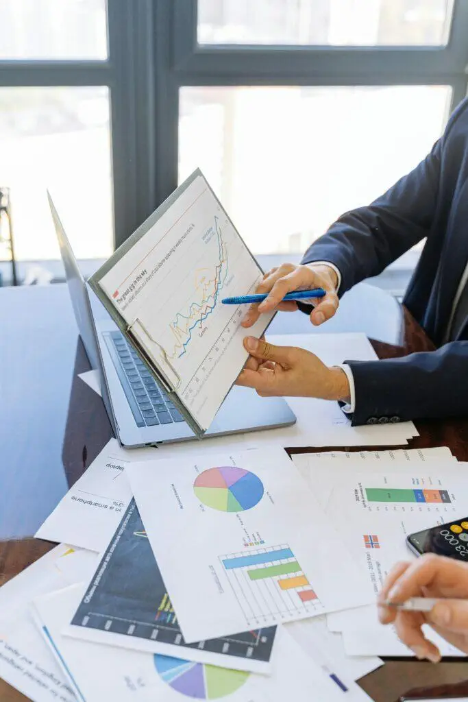 Businesspeople reviewing financial charts and graphs, discussing data analysis.